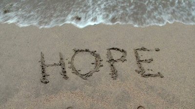 stock-footage-the-water-wipes-off-the-word-hope-written-in-sand